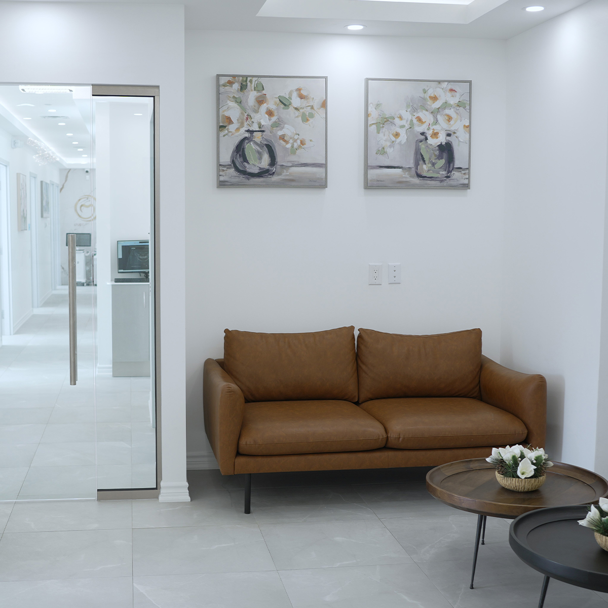 Waiting area with a leather sofa and framed artwork
