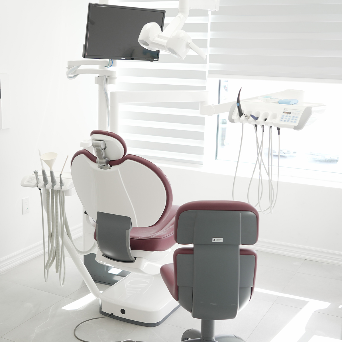 Treatment room with a dental chair and window blinds