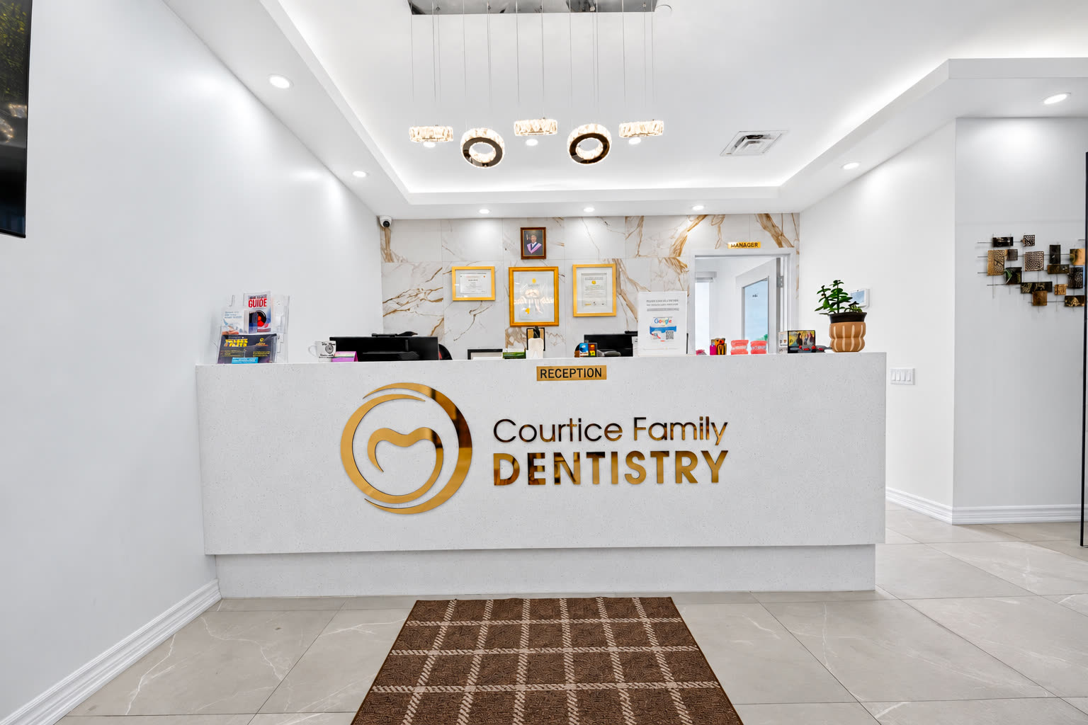 Reception desk with the gold Courtice Family Dentistry logo