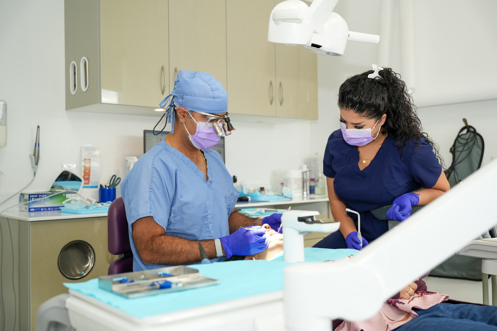 Dr. Vijay Singh and Shakila treating a patient at Courtice Family Dentistry