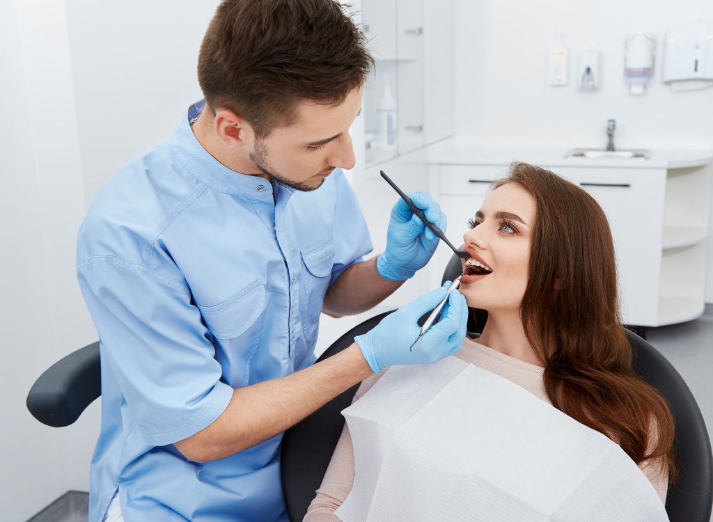 A dentist examining a patient's teeth