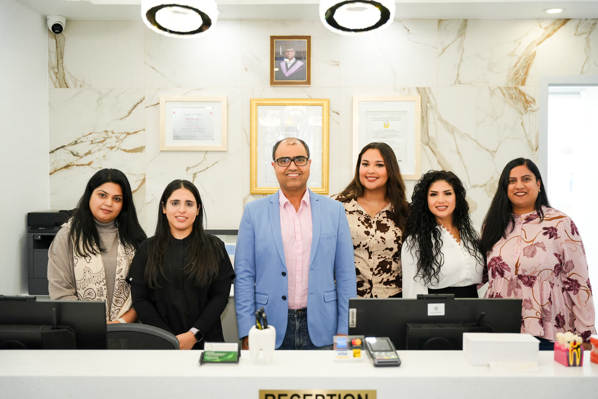 The Courtice Family Dentistry team behind the reception desk